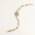 Gold-plated bracelet with pink baroque pearl centerpiece, floral connector, and freshwater pearls
