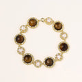 Gold-plated link bracelet with alternating brown tiger's eye stones and white freshwater pearls in ornate bezels.