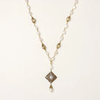 Y-shaped necklace with freshwater pearls, gold filigree stations, and ornate diamond-shaped centerpiece with pearl drop