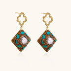 Gold-plated drop earrings with quatrefoil studs, diamond-shaped pendants featuring baroque pearls, turquoise stones, and amber crystals
