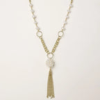 Long gold-plated necklace with freshwater pearls, chunky chain links, and flowing tassel pendant