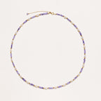 Delicate 18K gold vermeil necklace with alternating lavender zirconia beads and white freshwater pearls on cream background