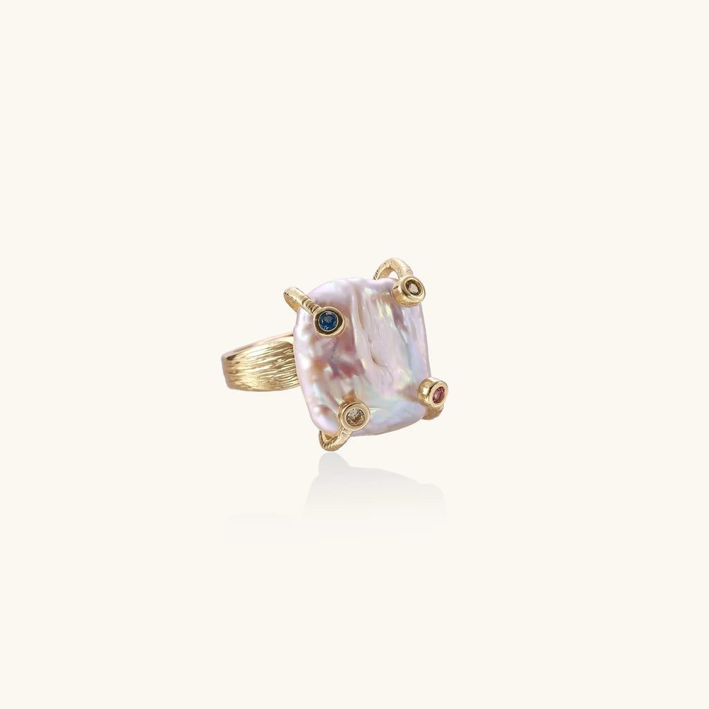 Gold ring with large iridescent baroque pearl and four colored gemstones on textured band