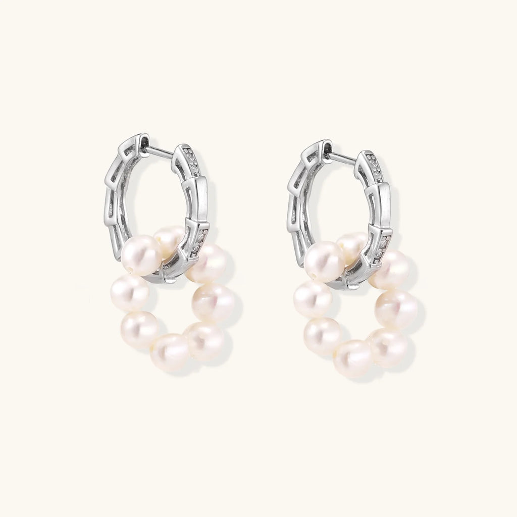 Rhodium-plated silver hoop earrings with freshwater pearls arranged in crescent formation and diamond accents