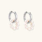 Rhodium-plated silver hoop earrings with freshwater pearls arranged in crescent formation and diamond accents