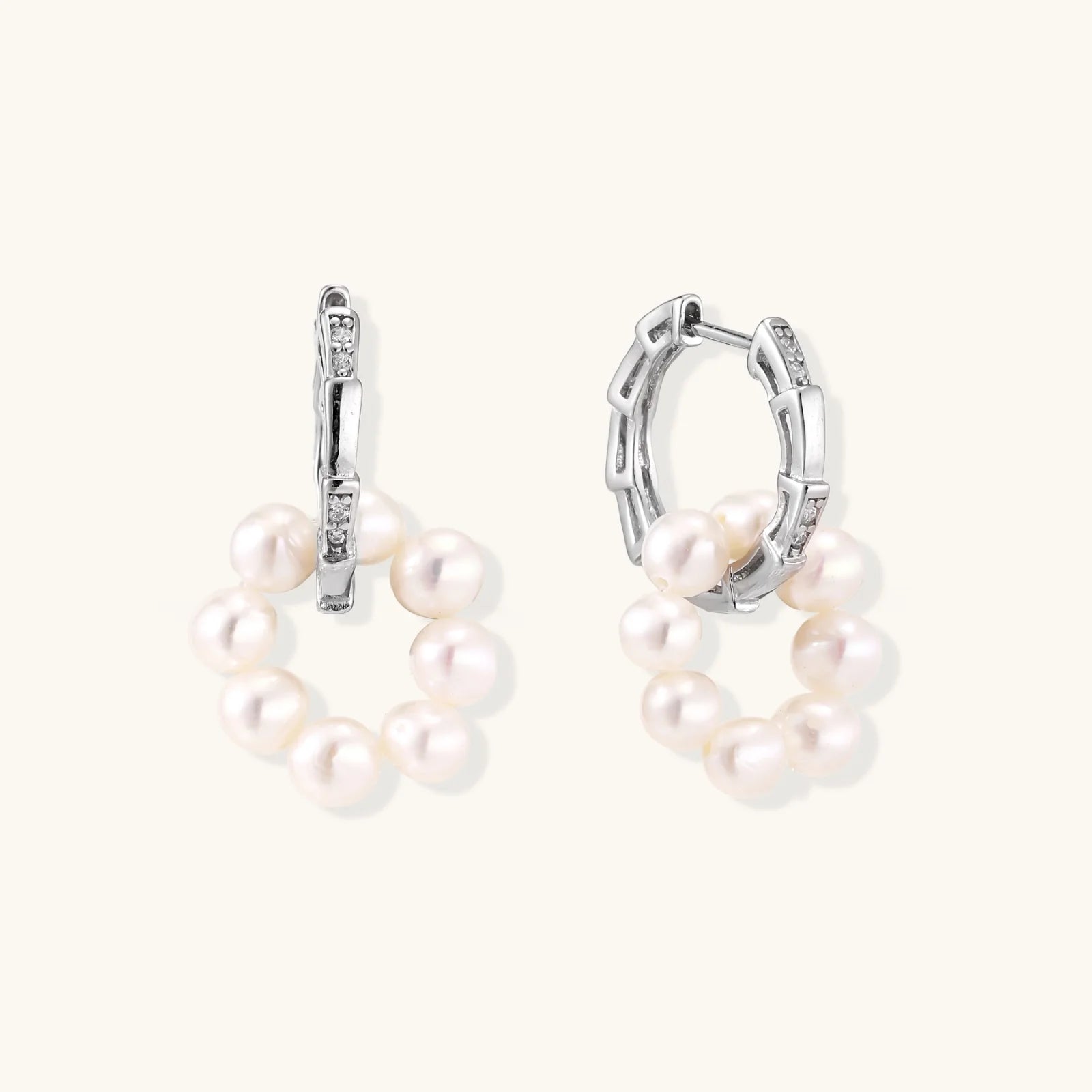 Rhodium-plated silver hoop earrings with freshwater pearls arranged in crescent formation and diamond accents