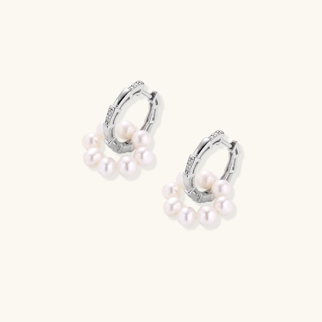 Rhodium-plated silver hoop earrings with freshwater pearls arranged in crescent formation and diamond accents