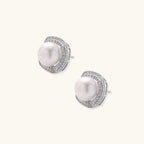 Cushion-shaped sterling silver stud earrings with freshwater pearls surrounded by geometric diamond halos