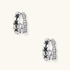 Triple-row white gold hoops with black X-pattern, twisted band, and pavé zirconia stones on white background.