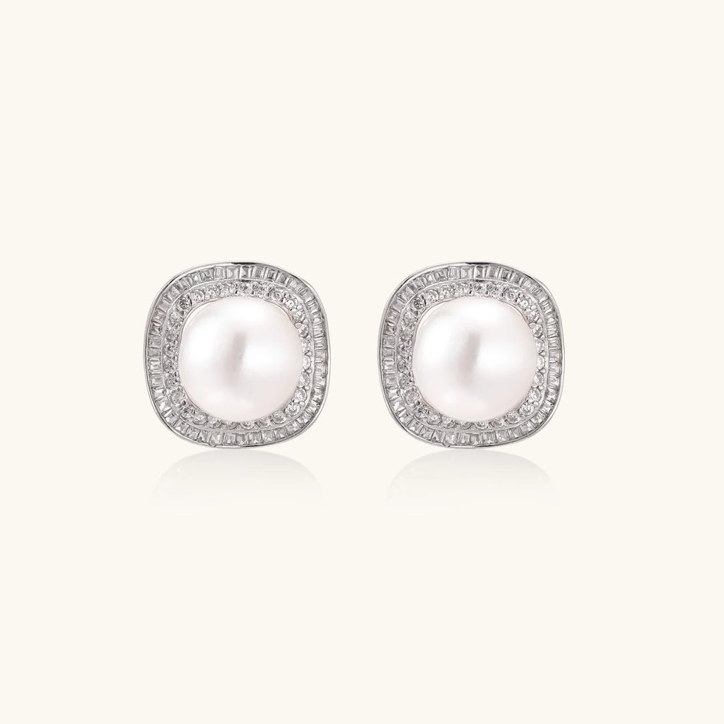 Cushion-shaped sterling silver stud earrings with freshwater pearls surrounded by geometric diamond halos