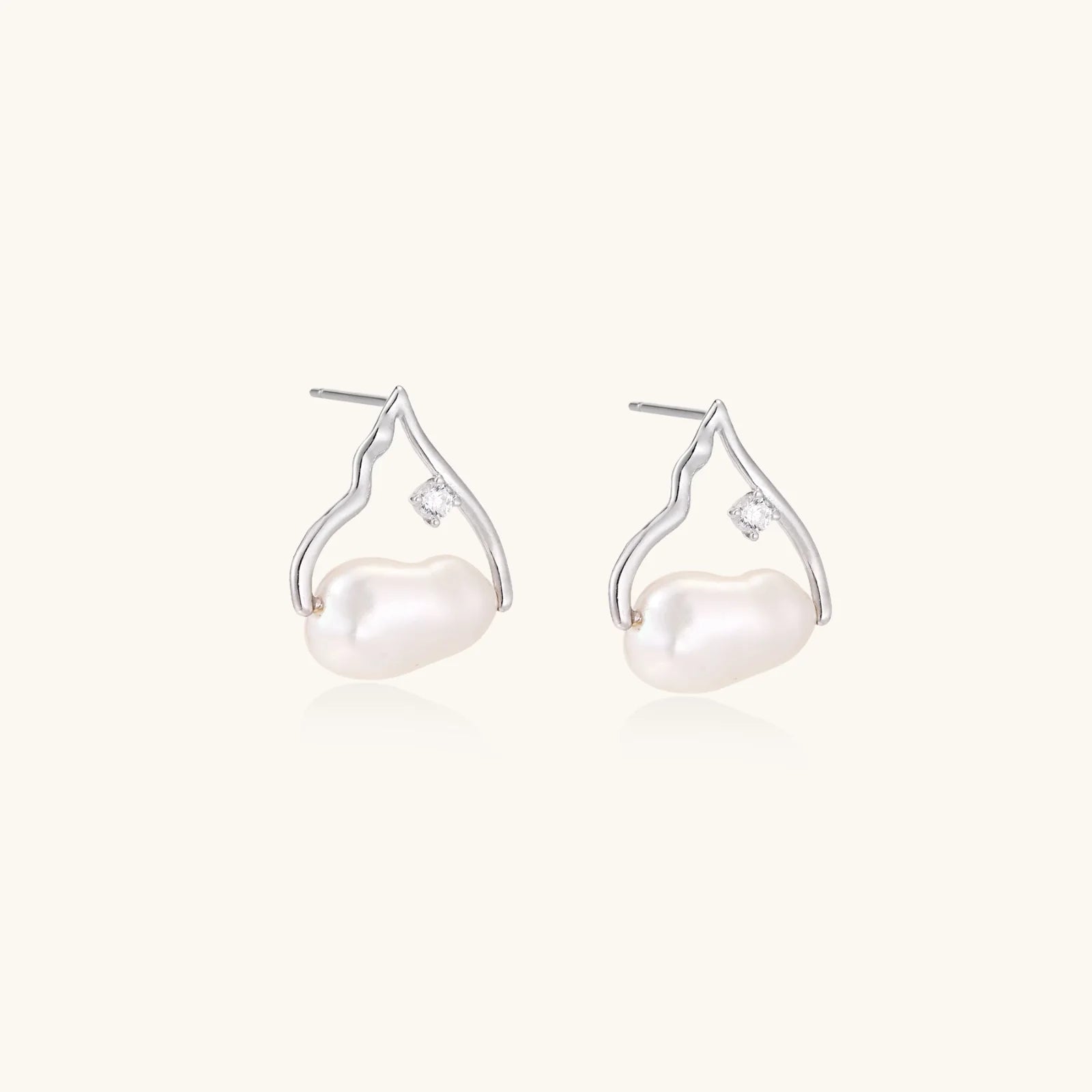 Silver mountain outline studs with baroque pearl and diamond accent on white background