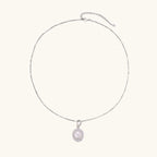 Oval sterling silver pendant with crystal halo surrounding a white freshwater pearl on delicate chain