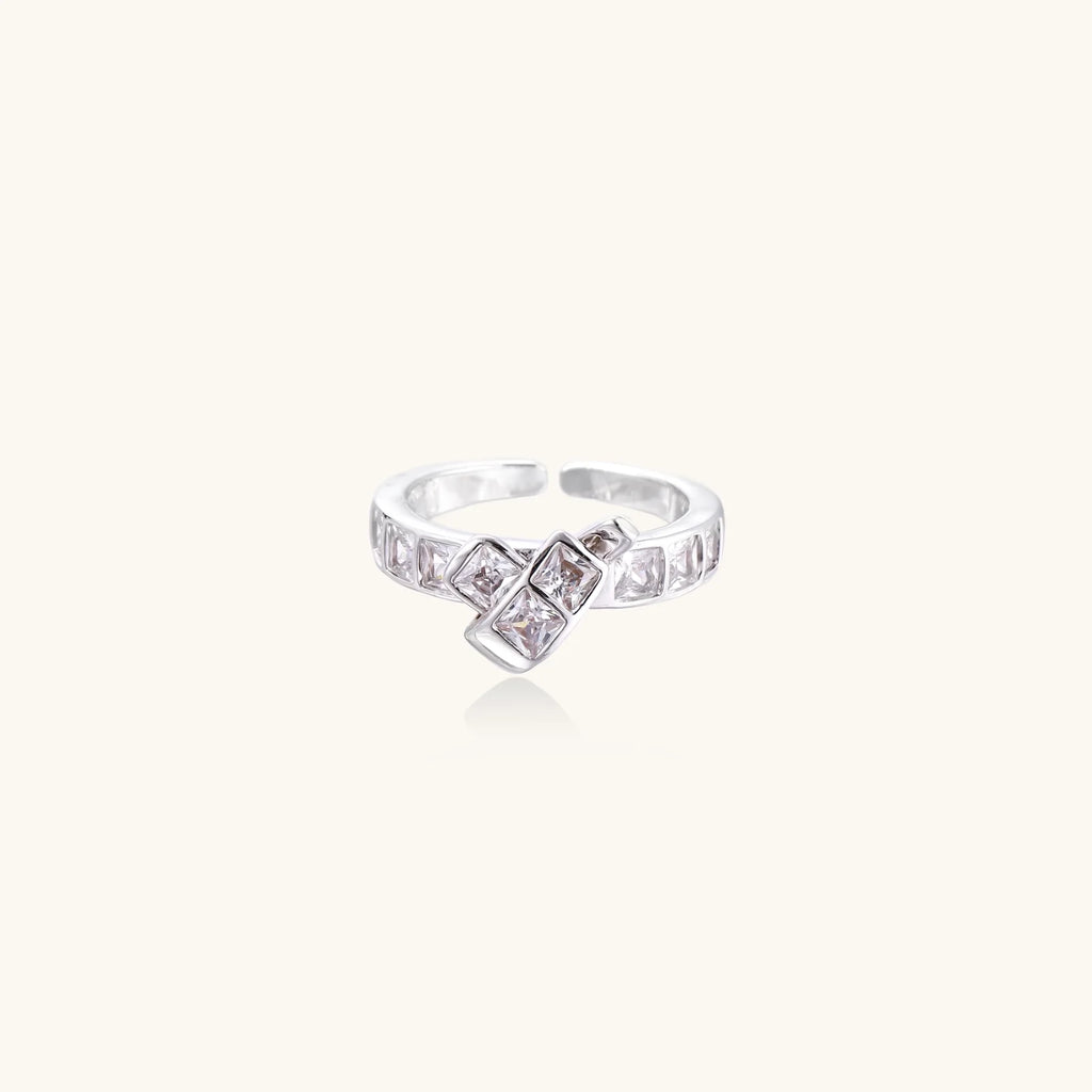 White gold plated adjustable ring featuring offset square cubic zirconia stones in an architectural stacked design