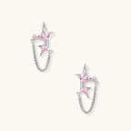 Pair of silver star-shaped ear climbers with pink zirconia stones connected by delicate chains