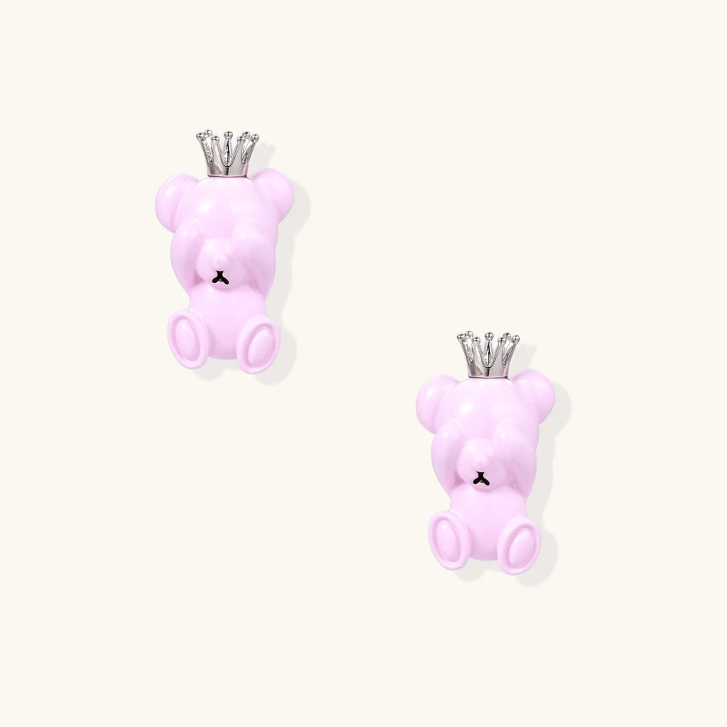 Lavender pink teddy bear earrings with silver crowns, white gold plated brass, viewed from back on cream background