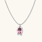 Translucent pink skull pendant with silver bow detail on delicate white gold plated chain against cream background