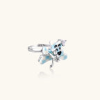 Adjustable white gold-plated ring with 3D blue enamel puppy wearing crystal crown on beige background