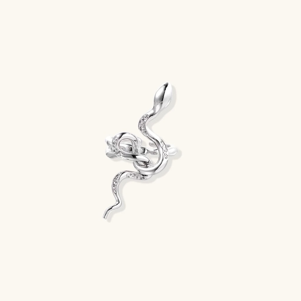 Sculptural white gold-plated snake ring with crystal accents coiling around finger in bold open design