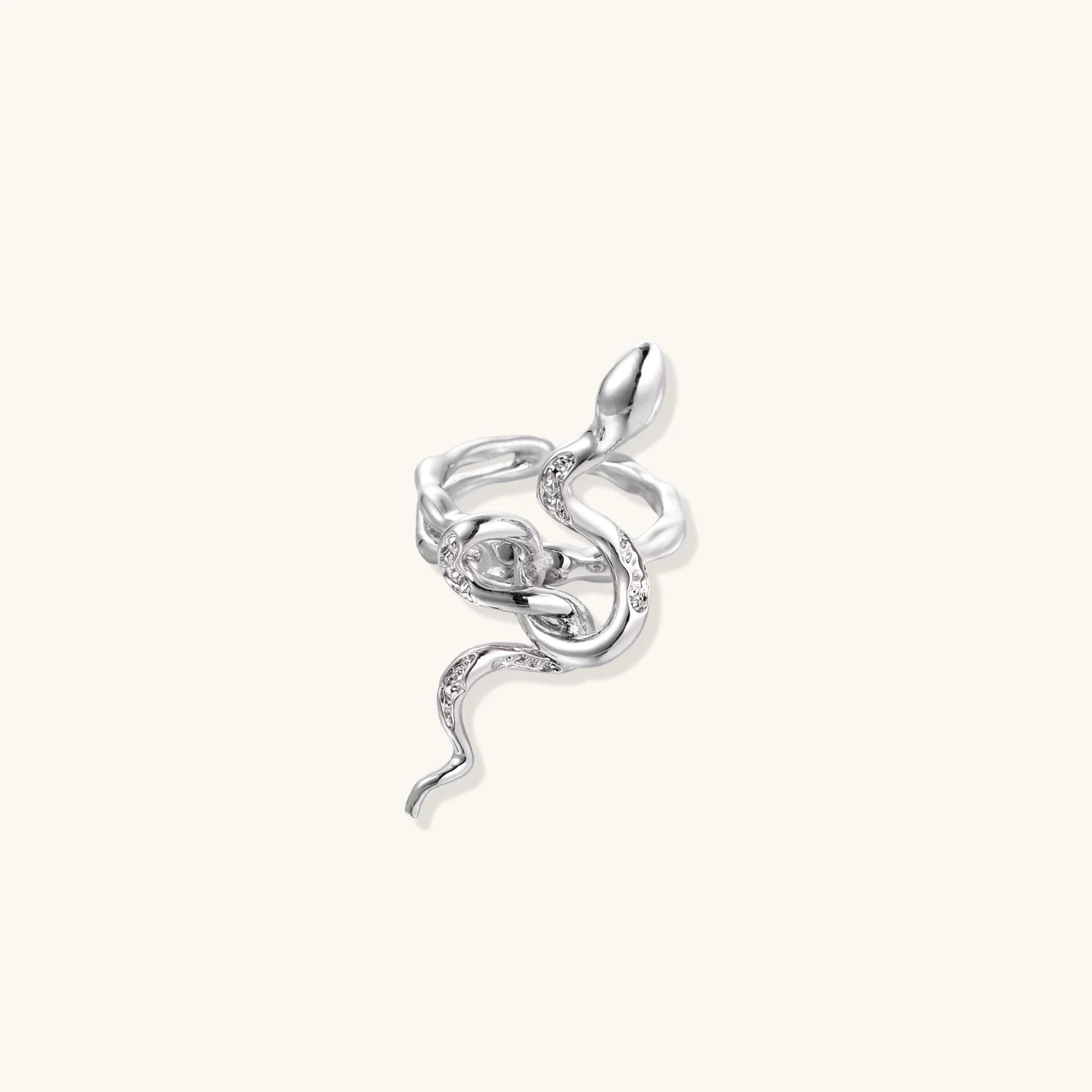 Sculptural white gold-plated snake ring with crystal accents coiling around finger in bold open design