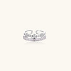 Silver-toned adjustable crown ring with channel-set square zirconia stones and delicate floral details on white background