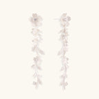 Long sterling silver drop earrings with delicate floral vine design and crystal accents on white background