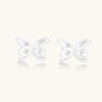 Pair of translucent butterfly-shaped stud earrings with frosted finish and dimensional wing details on white background