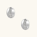 White gold-plated dome hoop earrings with geometric lattice pattern and zirconia stones on cream background