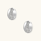 White gold-plated dome hoop earrings with geometric lattice pattern and zirconia stones on cream background