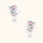 Coastal earrings with enamel cowrie shell, white pearls, starfish charm, and teardrop crystal on silver-toned metal