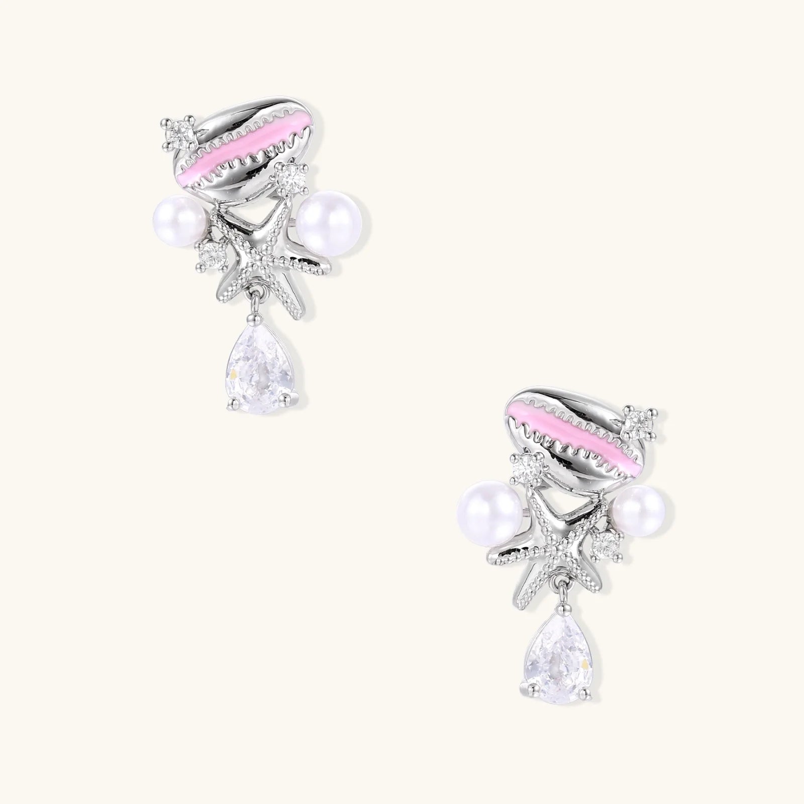 Coastal earrings with enamel cowrie shell, white pearls, starfish charm, and teardrop crystal on silver-toned metal