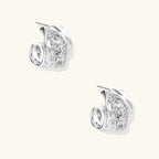 Close-up of sculptural hoop earrings with lattice center band and smooth twisted edges in white gold-plated brass with zirconia