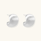 Brushed sterling silver cushion-shaped stud earrings with matte finish on white background