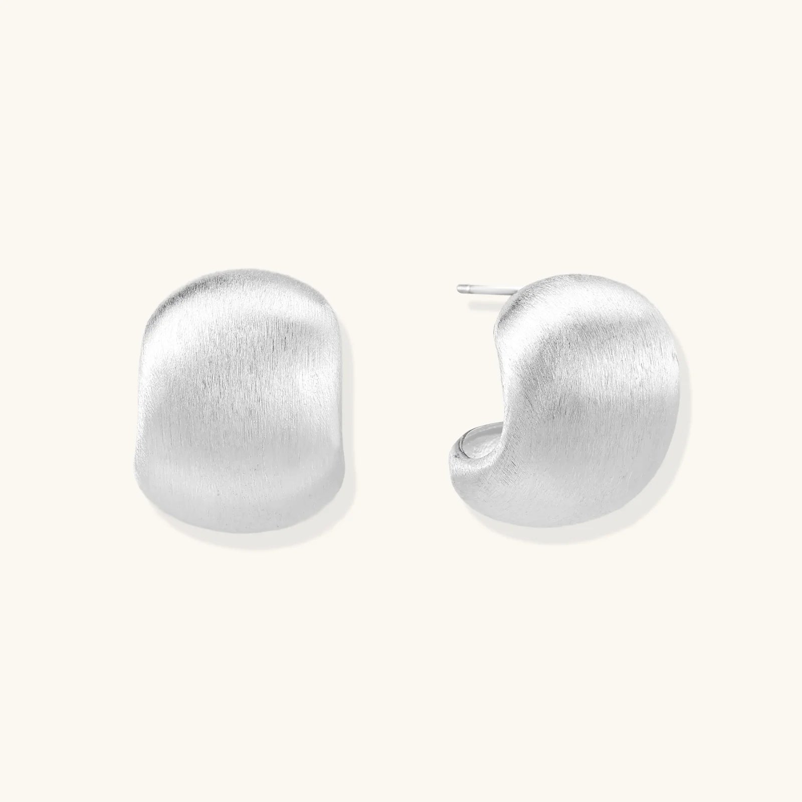 Brushed sterling silver cushion-shaped stud earrings with matte finish on white background