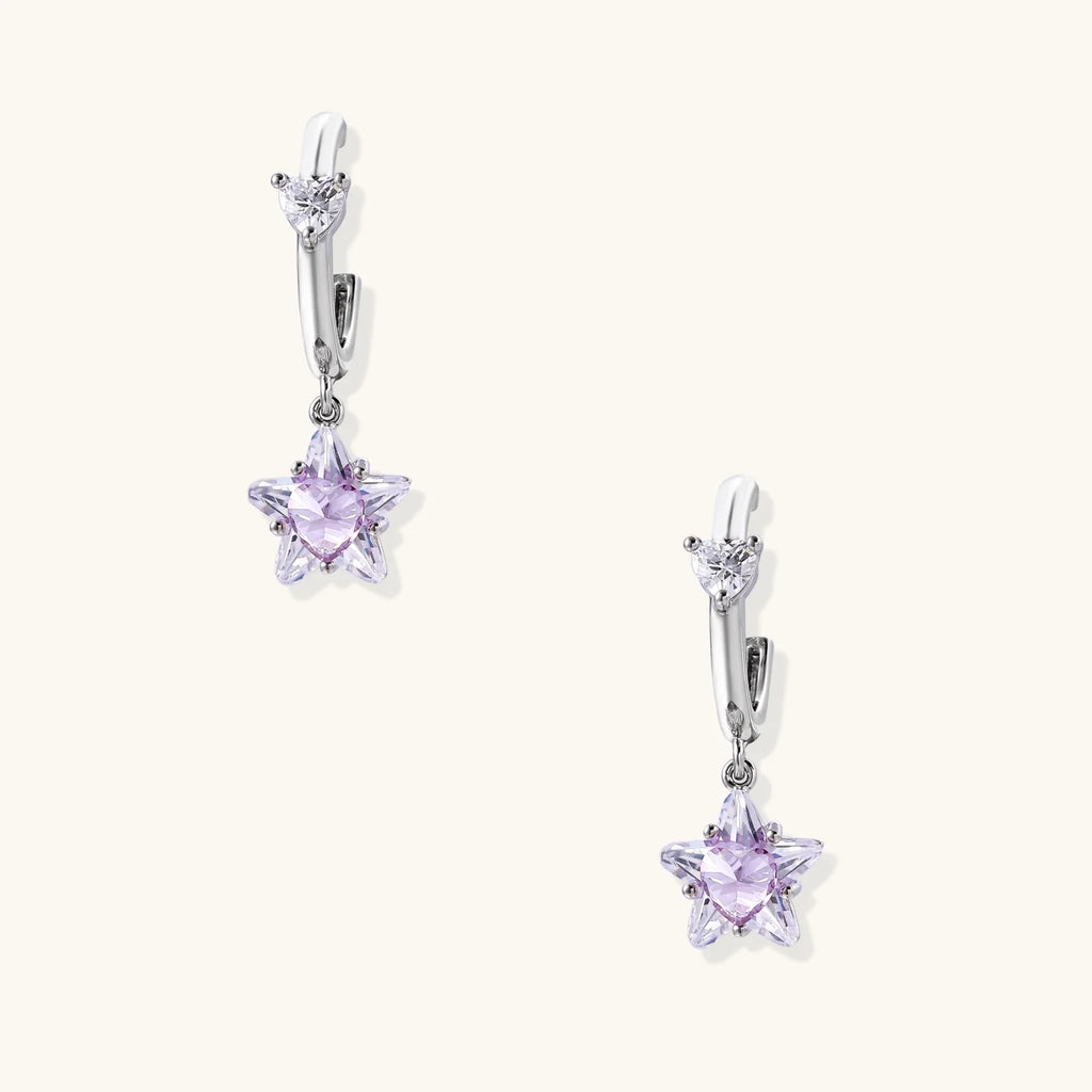 White gold plated huggie earrings with clear CZ accents and dangling lavender star-shaped crystals on cream background
