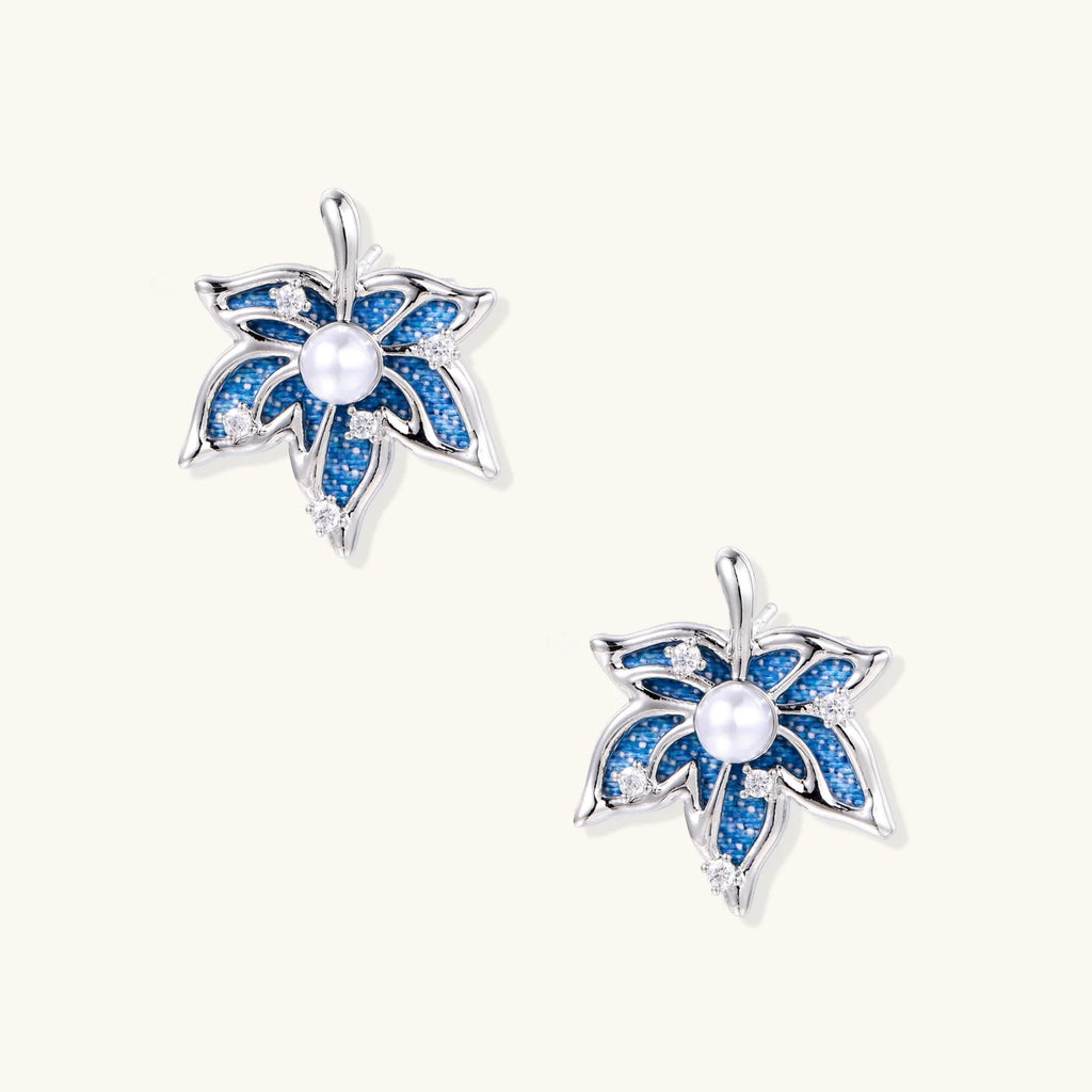 Blue denim fabric star-flower stud earrings with white pearl center and crystal accents on white gold-plated frame