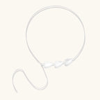 Minimalist sterling silver necklace with three brushed leaf-shaped pendants on delicate chain against white background