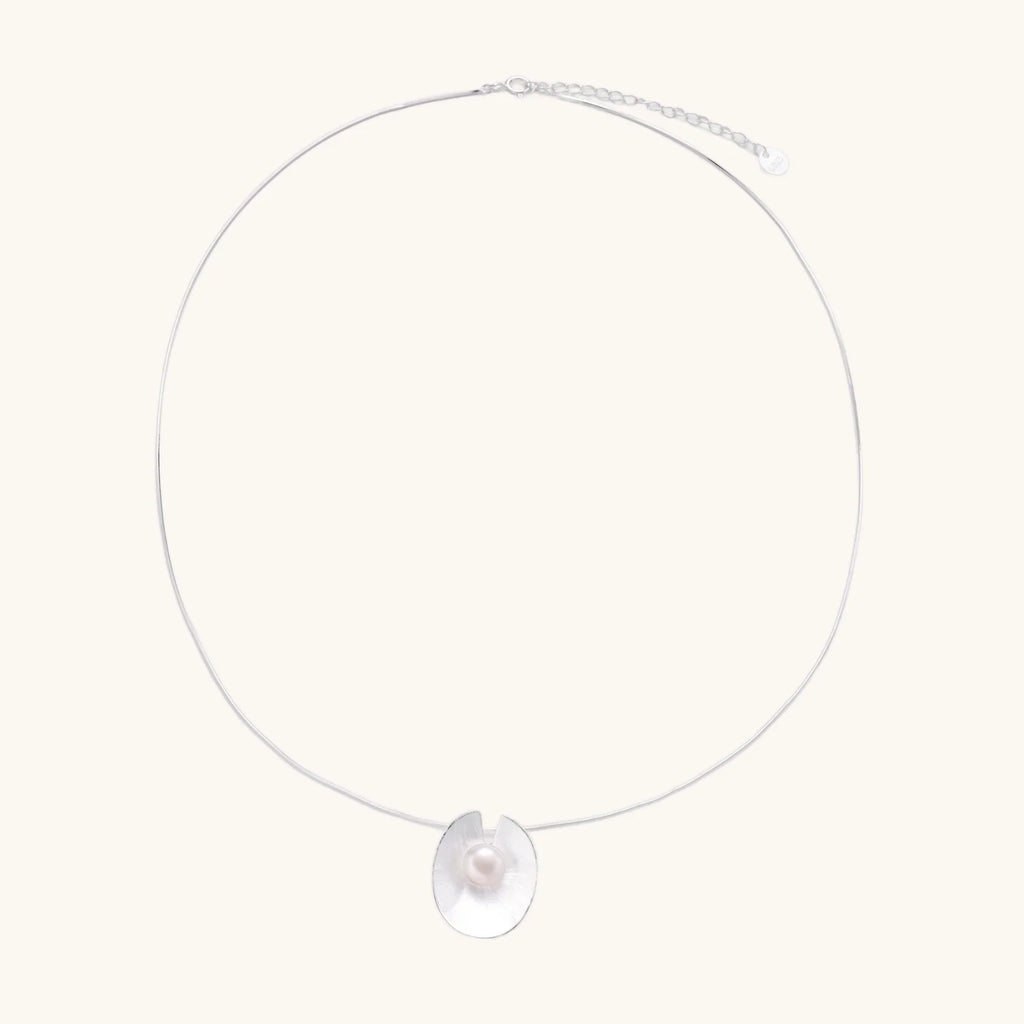 Sterling silver disc necklace with textured finish and centered freshwater pearl on delicate chain