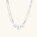 Sterling silver multi-strand necklace with three brushed round beads on cream background