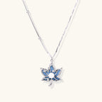 White gold-plated lotus pendant with blue denim fabric inlay and sparkling zirconia stones on adjustable chain