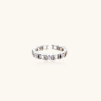 White gold plated ring with architectural lattice design and zirconia accents on cream background