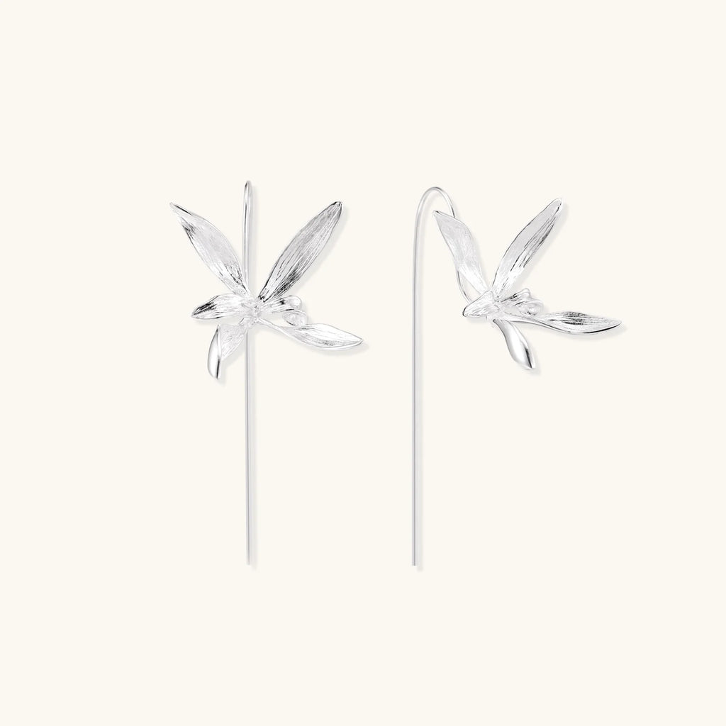 Delicate sterling silver dragonfly earrings with textured wings and curved threader hooks on white background