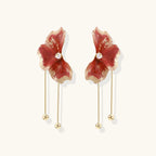 Red enamel flower earrings with gold-plated stems, central pearl, and gradient coral-to-gold petals on white background