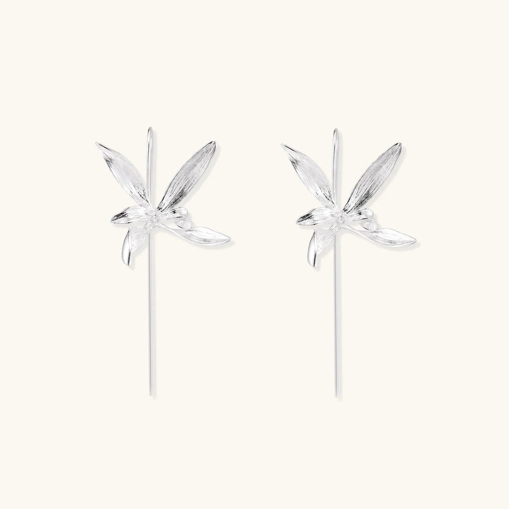 Delicate sterling silver dragonfly earrings with textured wings and curved threader hooks on white background