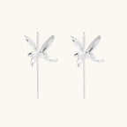 Delicate sterling silver dragonfly earrings with textured wings and curved threader hooks on white background