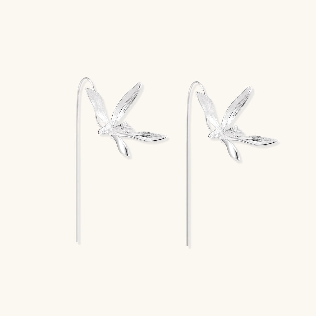 Delicate sterling silver dragonfly earrings with textured wings and curved threader hooks on white background