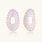 Oval lavender enamel earrings with marbled finish and gold-plated beaded border on cream background.