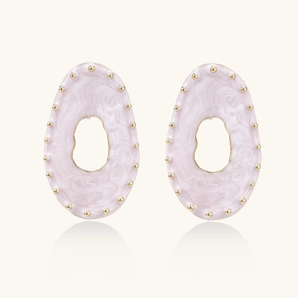 Oval lavender enamel earrings with marbled finish and gold-plated beaded border on cream background.