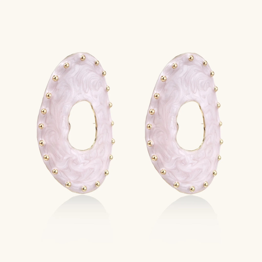 Oval lavender enamel earrings with marbled finish and gold-plated beaded border on cream background.