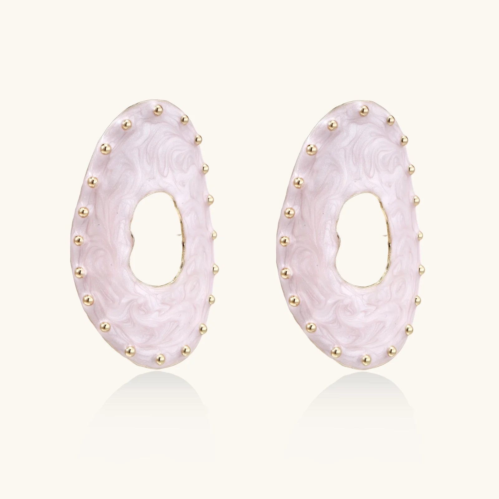 Oval lavender enamel earrings with marbled finish and gold-plated beaded border on cream background.