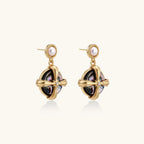 Gold-plated drop earrings with iridescent abalone shell and pearl studs in geometric cross design